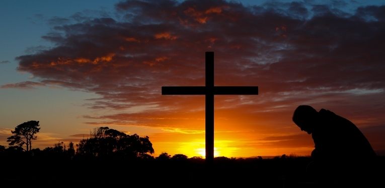 Christian cross at sunset