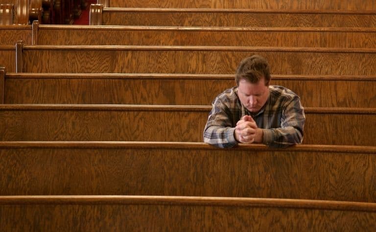 man praying in a Catholic church