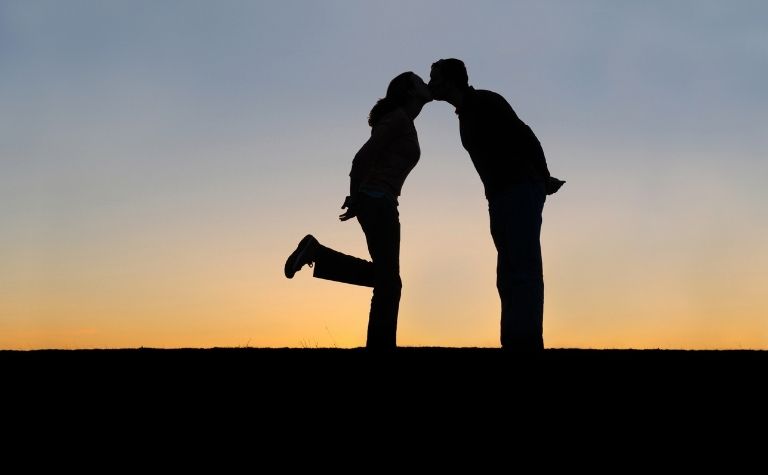 man and woman kissing